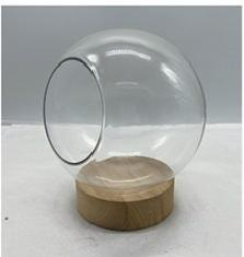 Clear glass ball with wooden base