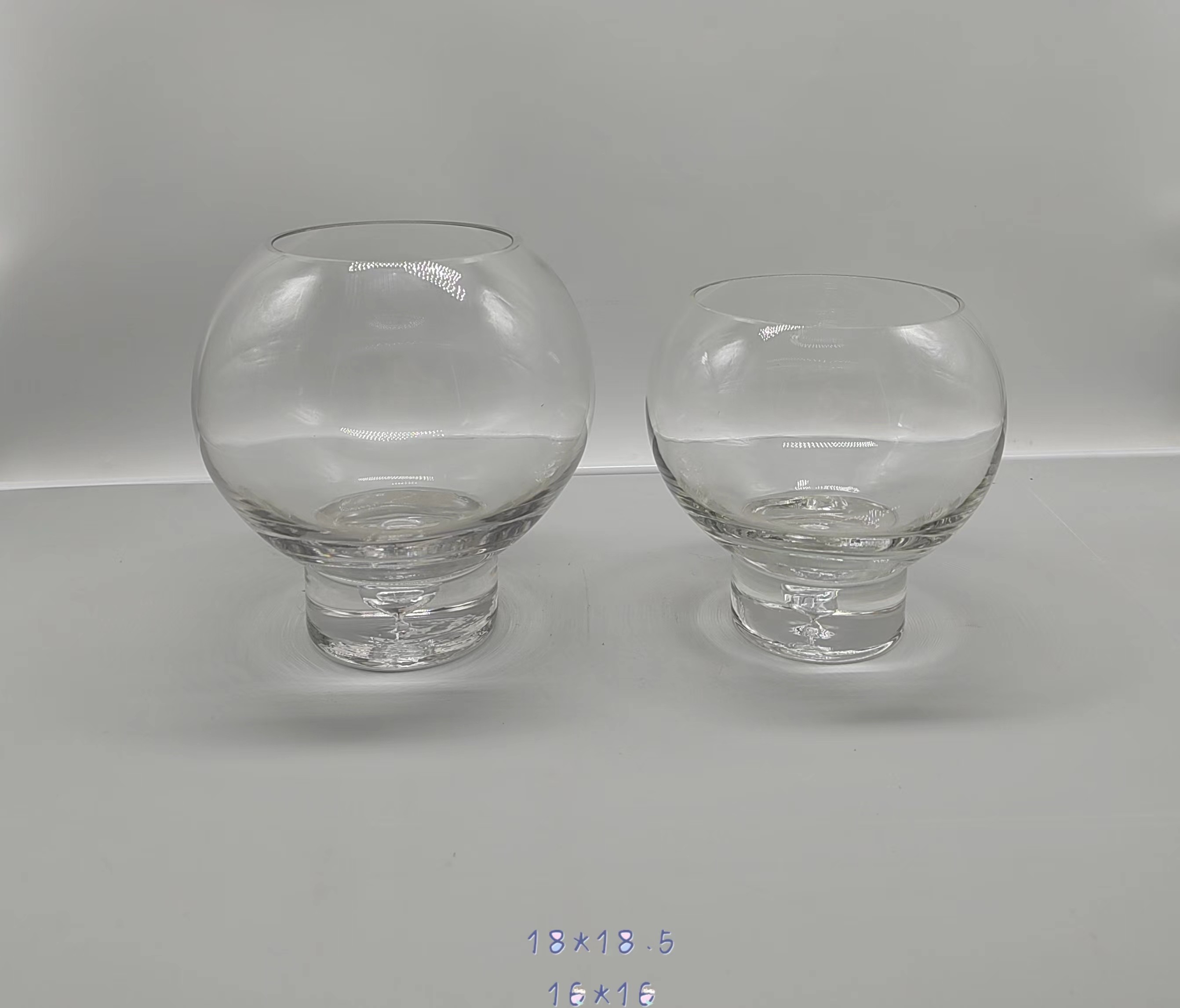 A group of clear glass candle holder